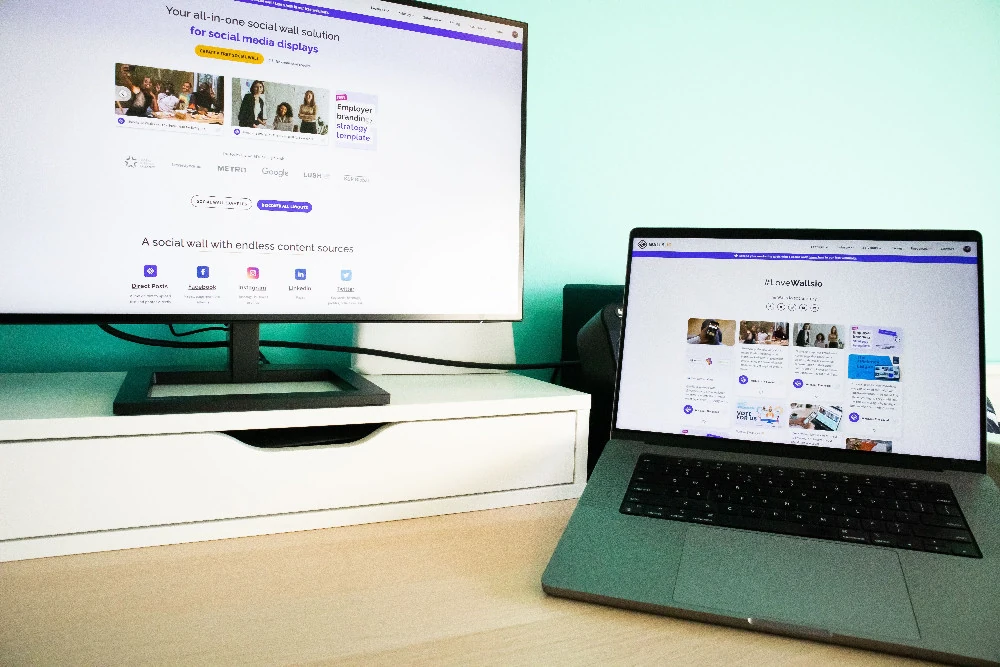 Creative web design studio workspace with large digital display and design tools