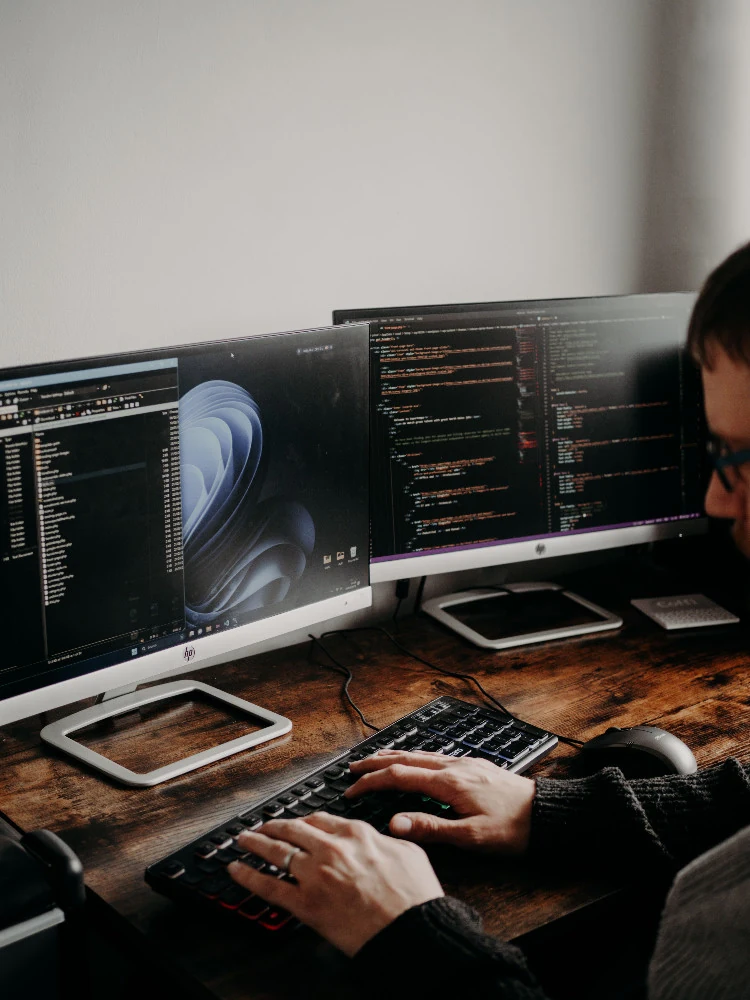Futuristic web development workspace with multiple displays and digital interfaces